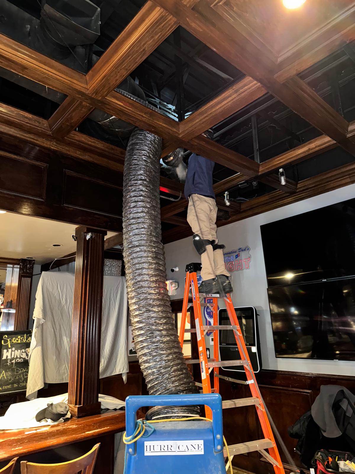 Sports bar — supply duct source-removal cleaning through coffered ceiling panel